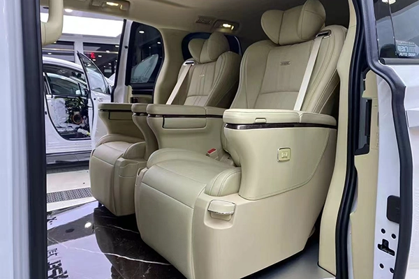 Pair of cream beige leather captain seats installed in van, foldable armrest and built-in safety belt