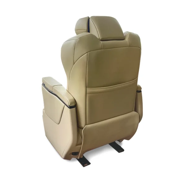 Rear view of a luxury Alphard captain seat in beige leather, showing the smooth backrest finish, integrated magazine pocket, and sturdy seat rail mounting.