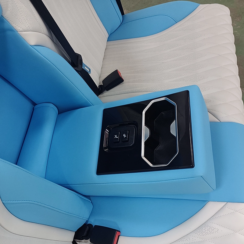 Close-up of back seat of car fold-down center armrest fitted with control switches and cup slot
