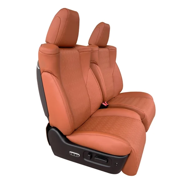Side angle shot of brown perforated car driver seat equipped with side physical control buttons