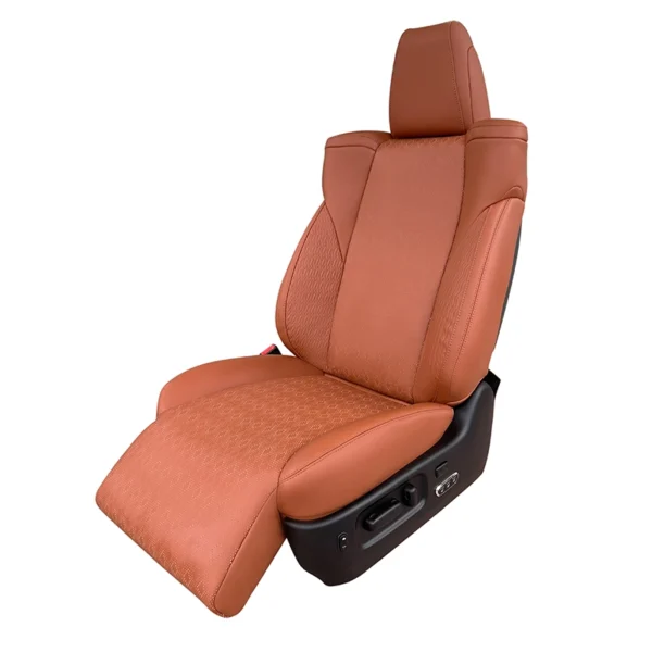 Front side shot of brown perforated car driver seat equipped with stretchable leg footrest