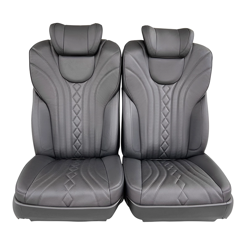 Front view of a pair of luxury driver passenger seats with diamond stitching.