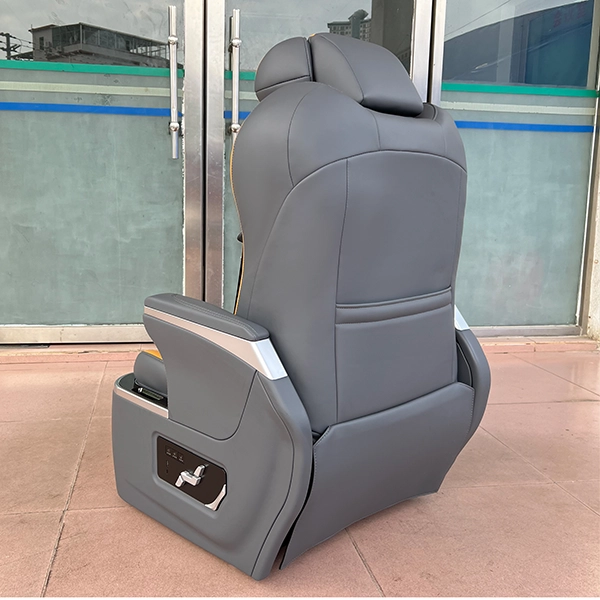 Rear view of luxury auto seats featuring a smooth grey leather finish and a built-in storage pocket for passenger convenience.