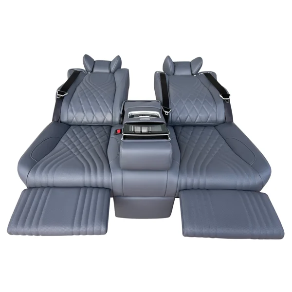 Gray leather luxury car back seat fully laid flat at 180 degrees with independent electric leg rests and center armrest