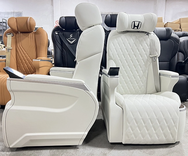 Front & side dual angle photo of white quilted leather Sienta captain seat with touch screen controller