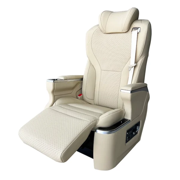 A luxury VIP captain seat upholstered in beige Nappa leather with the electric leg rest fully extended for ergonomic support.
