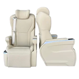 Front and side profiles of a luxury VIP captain seat upholstered in beige Nappa leather, featuring integrated seatbelt and power leg rest.