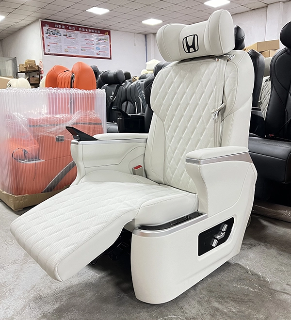 Front side shot of white quilted Sienta captain seat with fully stretched electric leg footrest