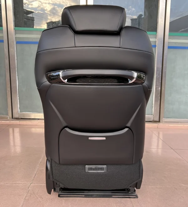Rear view of black leather passenger seat showing stylish integrated backrest structure