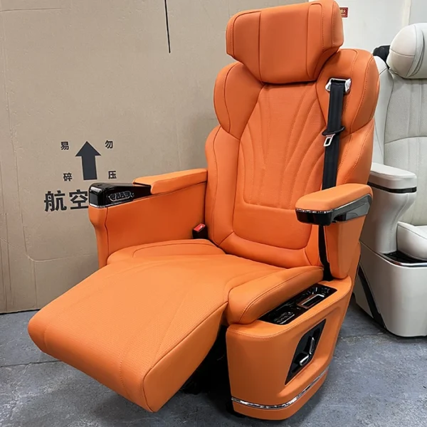 Close-up of an orange captain seat van with the electric leg rest fully extended for comfort.