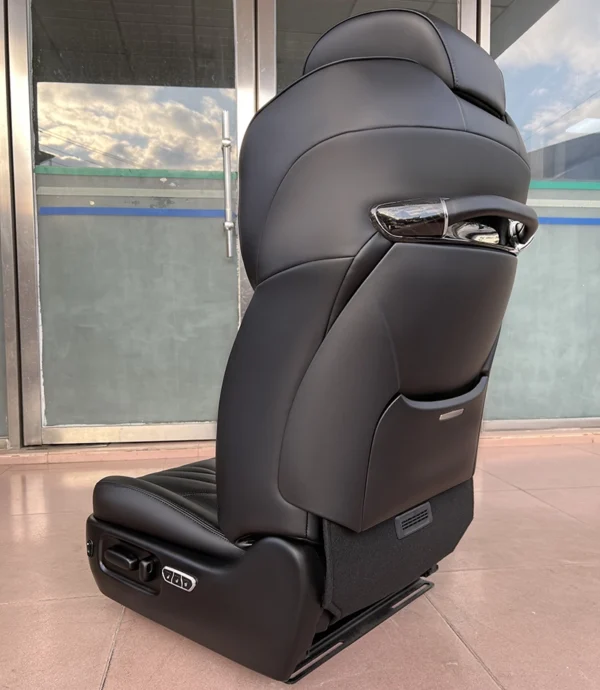 Side rear view of leather passenger seat with stylish backrest and side physical control switches