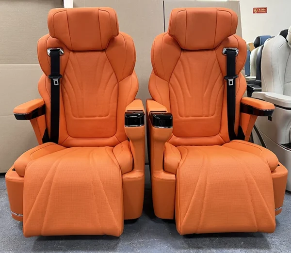 A pair of luxury orange leather captain seat van with armrests and leg support for MPV conversion.