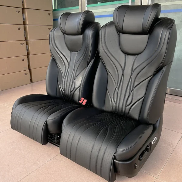 Two matching leather passenger seats equipped with extended electric leg rest for comfort